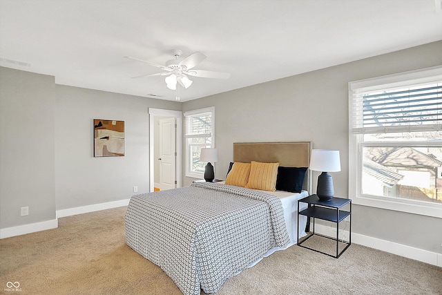 bedroom with light carpet, visible vents, ceiling fan, and baseboards