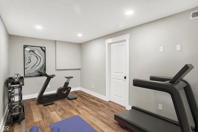 exercise room featuring visible vents, recessed lighting, baseboards, and wood finished floors