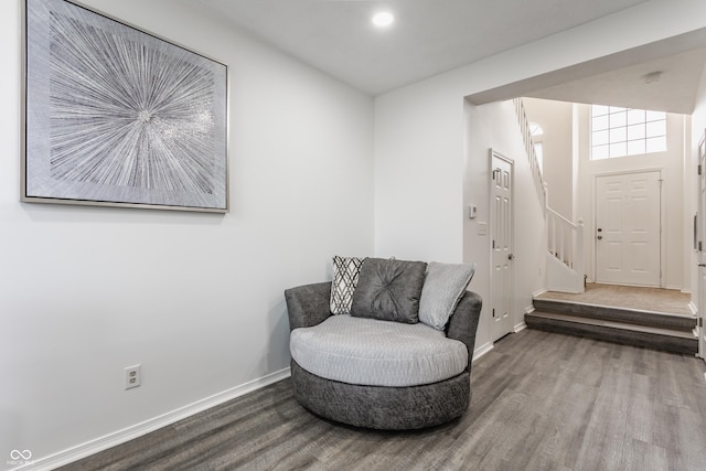 sitting room featuring stairway, baseboards, wood finished floors, and recessed lighting