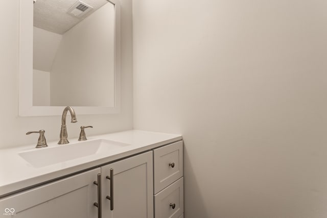 bathroom featuring visible vents and vanity