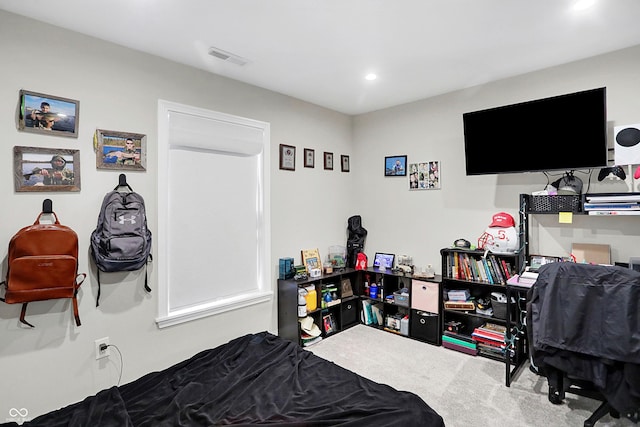 carpeted bedroom featuring visible vents