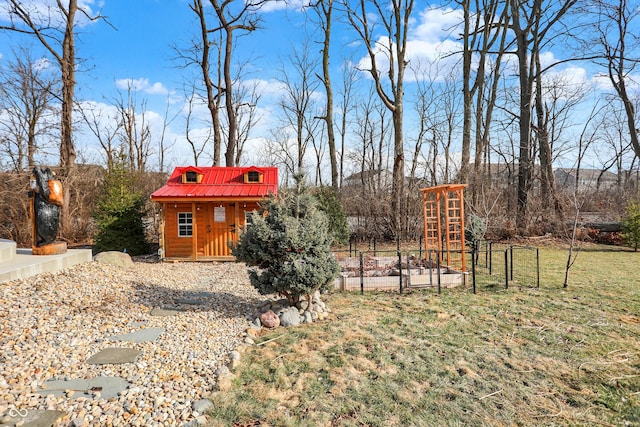 view of yard featuring a garden and an outbuilding