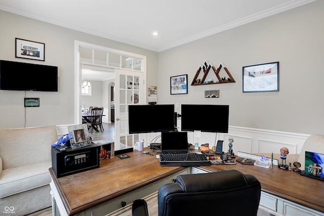 office featuring arched walkways, a wainscoted wall, recessed lighting, a decorative wall, and ornamental molding