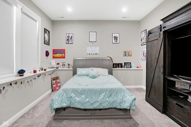 carpeted bedroom with recessed lighting, baseboards, and a barn door