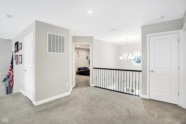 corridor with carpet floors, visible vents, baseboards, and an inviting chandelier