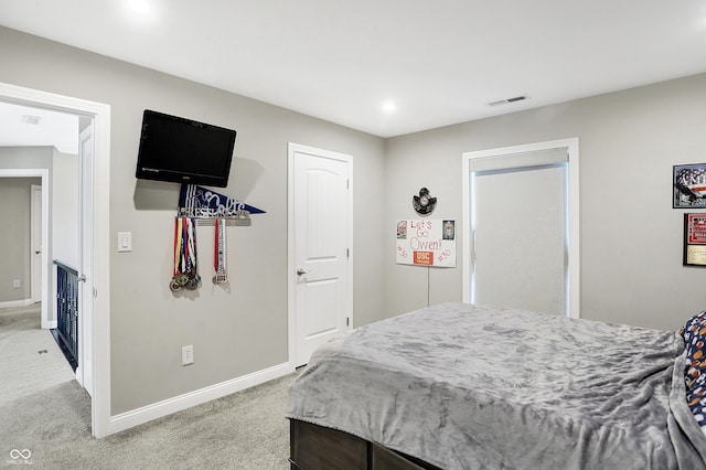 bedroom with light carpet, visible vents, and baseboards