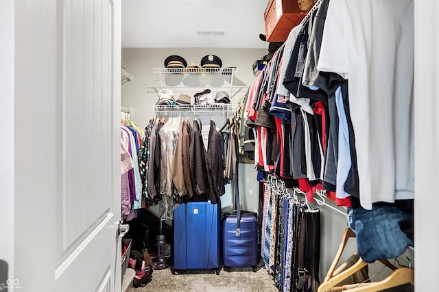 spacious closet featuring visible vents and carpet flooring