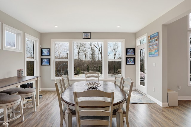 dining space featuring light wood-type flooring, baseboards, and recessed lighting