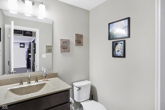 bathroom featuring toilet and vanity