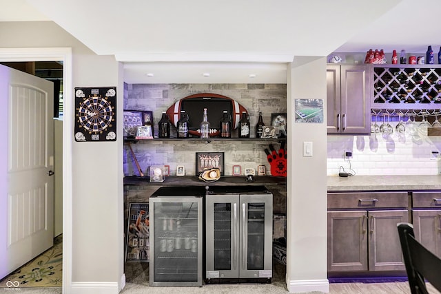 bar featuring beverage cooler, a dry bar, and tasteful backsplash