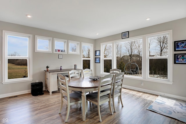 dining room with recessed lighting, baseboards, visible vents, and light wood finished floors