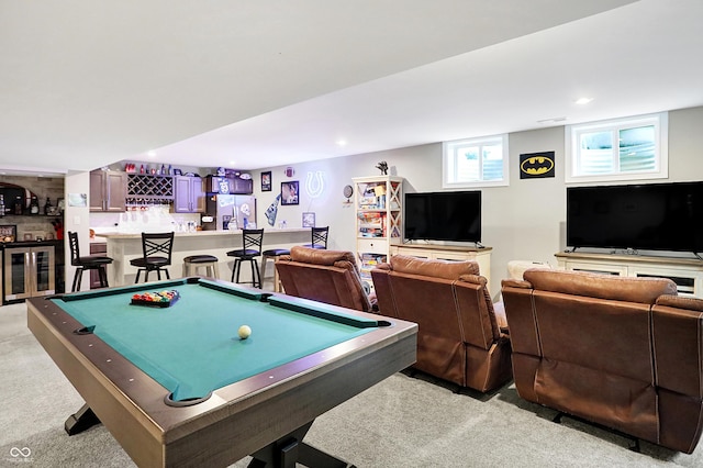 recreation room featuring a bar, light carpet, and recessed lighting