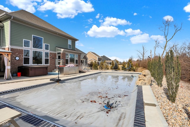 view of pool featuring a patio area, a pool, and a hot tub