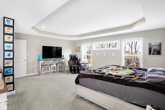 carpeted bedroom with baseboards, a tray ceiling, and recessed lighting