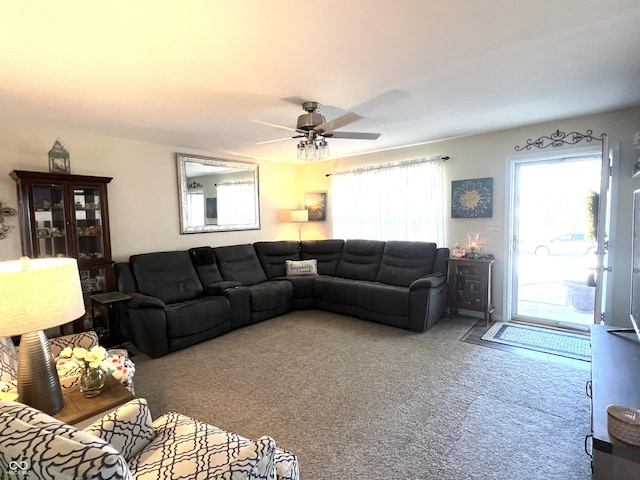 living room with ceiling fan and carpet flooring