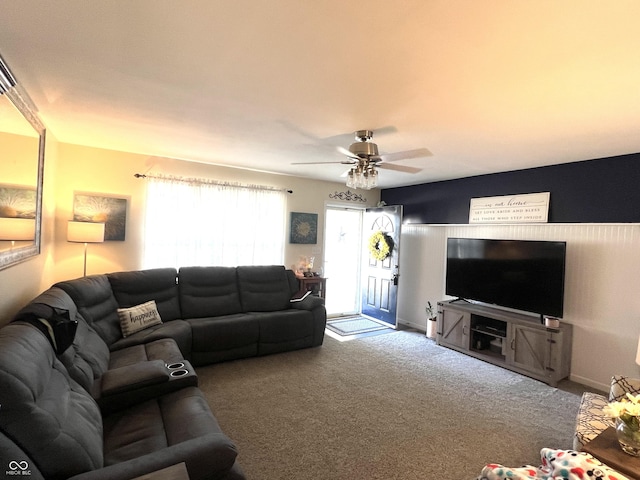 carpeted living room featuring a ceiling fan