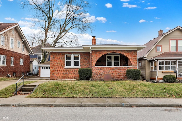 view of front facade featuring a garage, brick siding, concrete driveway, a front lawn, and a chimney