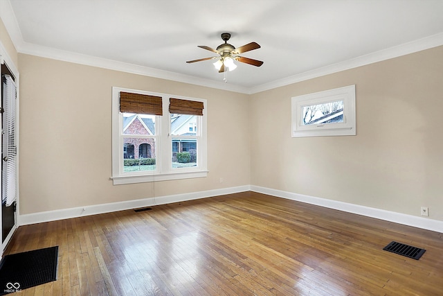 spare room with visible vents, crown molding, baseboards, and hardwood / wood-style floors