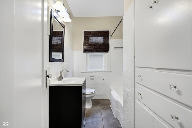 full bathroom with toilet, a wainscoted wall, tile patterned floors, vanity, and tile walls