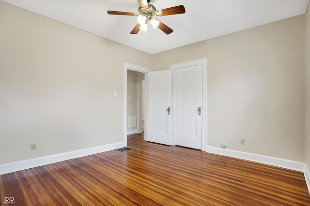 unfurnished bedroom featuring visible vents, ceiling fan, baseboards, and hardwood / wood-style flooring