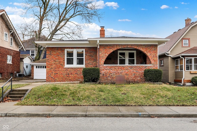 view of front facade with central AC unit, brick siding, a chimney, and a front yard