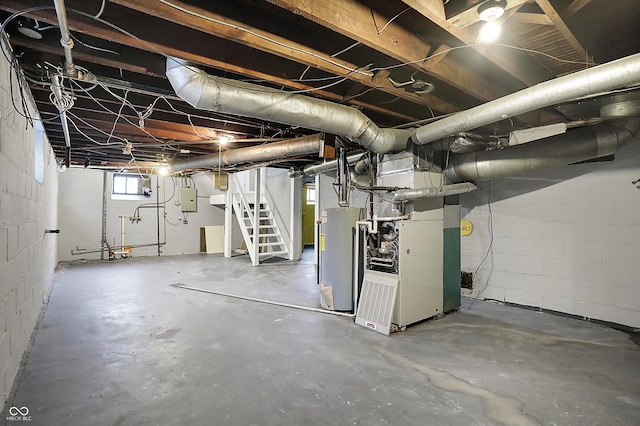 below grade area featuring gas water heater, electric panel, and heating unit