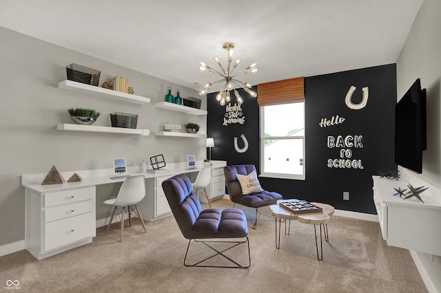 office area with light carpet, baseboards, an inviting chandelier, a textured ceiling, and built in desk