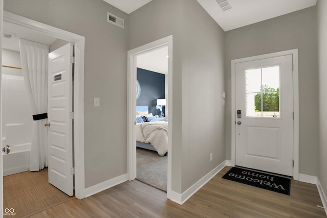 entryway with light wood-style floors, visible vents, and baseboards