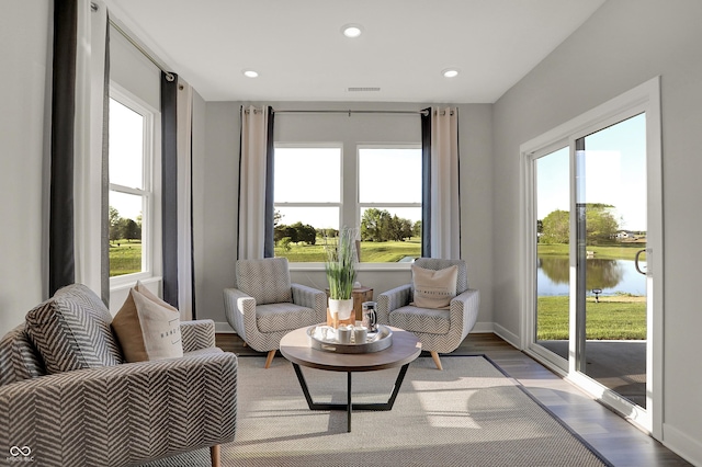 sitting room with recessed lighting, a healthy amount of sunlight, visible vents, and wood finished floors