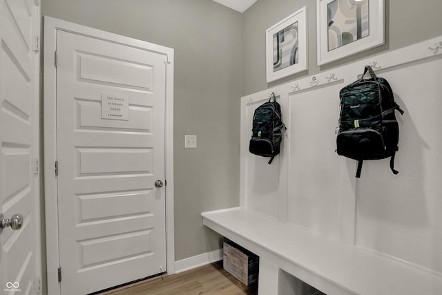 mudroom with light wood finished floors and baseboards