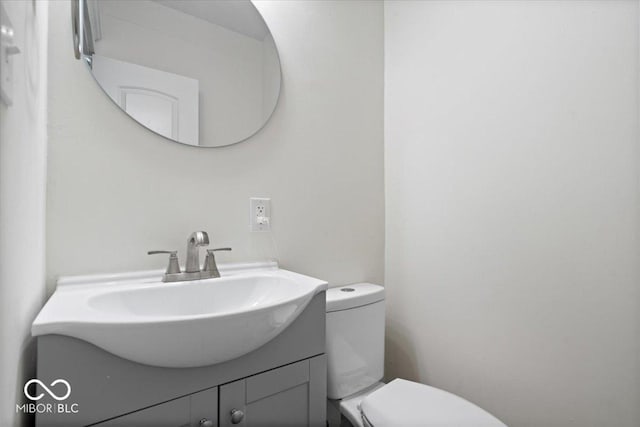 half bath featuring toilet and vanity