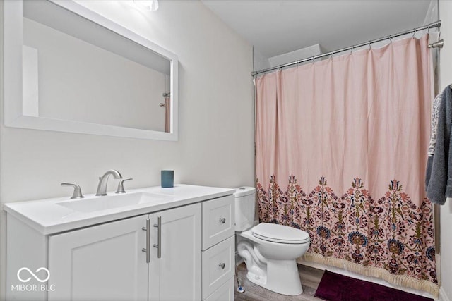 full bath with a shower with curtain, vanity, toilet, and wood finished floors