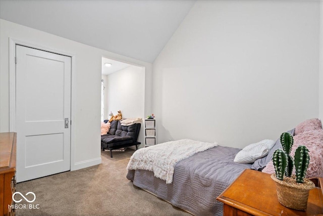 carpeted bedroom featuring lofted ceiling