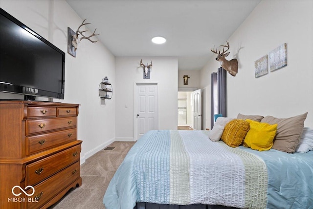 bedroom with baseboards, visible vents, and light colored carpet