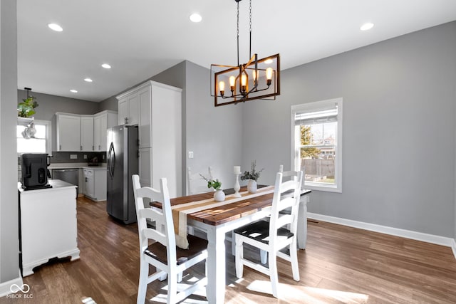 dining area featuring a healthy amount of sunlight, baseboards, and wood finished floors