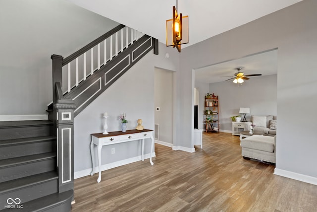 interior space with ceiling fan, wood finished floors, visible vents, and baseboards