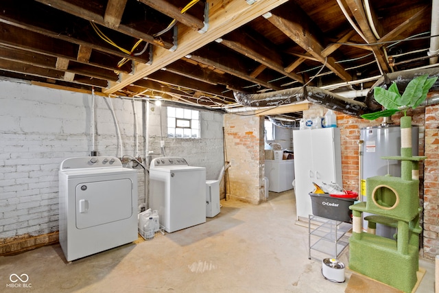 basement with washing machine and dryer and water heater