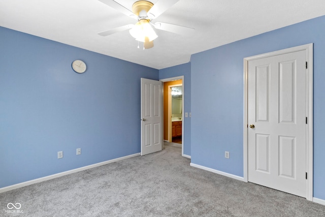 unfurnished bedroom featuring a ceiling fan, carpet, and baseboards