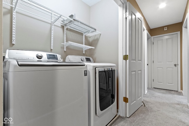 laundry area featuring light carpet, laundry area, and washer and dryer