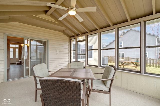 sunroom / solarium with ceiling fan and lofted ceiling with beams