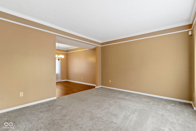 empty room with an inviting chandelier, baseboards, ornamental molding, and carpet flooring