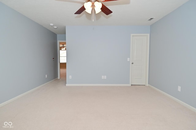 unfurnished room featuring ceiling fan, baseboards, visible vents, and light colored carpet