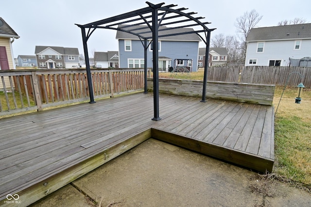 deck with a residential view, fence, and a pergola