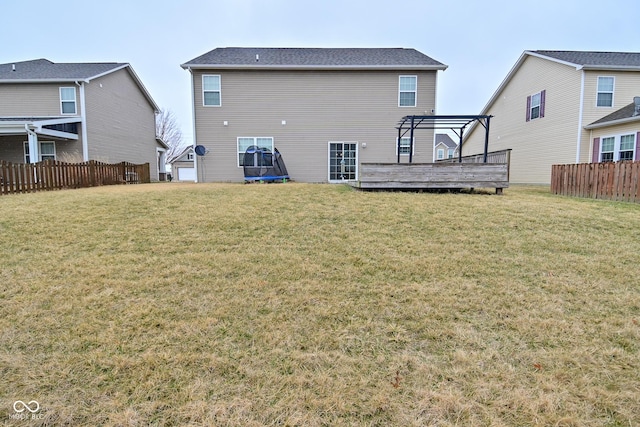 back of house with a yard, fence, and a wooden deck