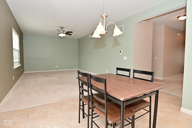 dining area with ceiling fan, light tile patterned floors, visible vents, and baseboards