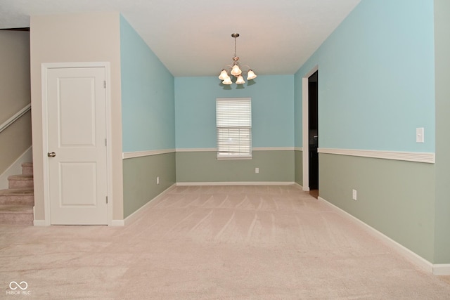 unfurnished room with stairs, baseboards, carpet flooring, and a chandelier