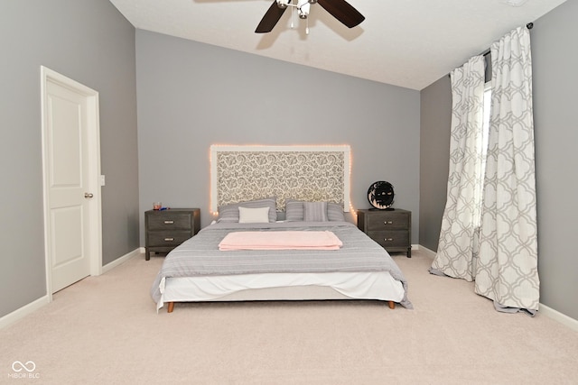 bedroom featuring lofted ceiling, a ceiling fan, baseboards, and carpet flooring