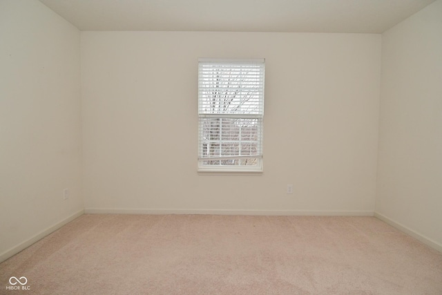 empty room with baseboards and carpet flooring