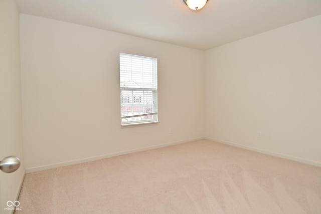 empty room with light carpet and baseboards