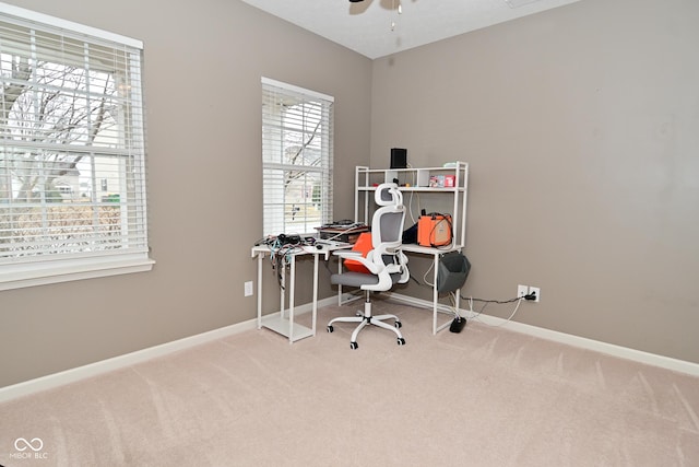 office area with carpet, ceiling fan, and baseboards